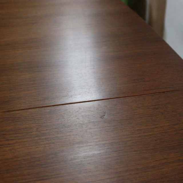 Vintage British mid-century teak dining table with rich wood grain and clean rectangular form.