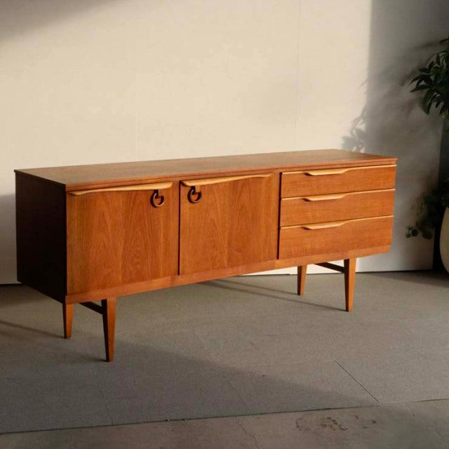 Vintage teak sideboard by Beautility with British mid-century design, featuring rich wood grain, two circular handles on.