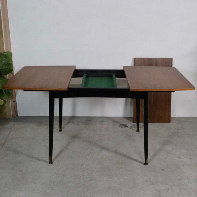 Mid-century vintage teak dining table with rectangular top, slender tapered black legs, and built-in green felt-lined.