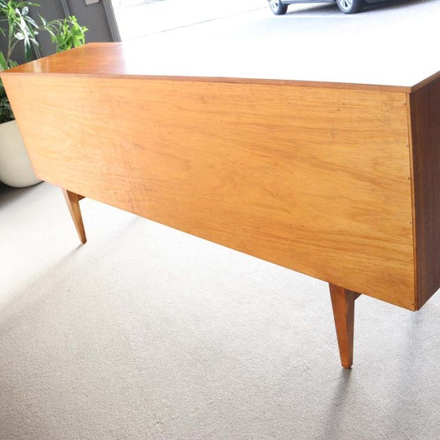 Mid-century British vintage teak sideboard by Beautility with sleek grain, tapered legs, and minimalist form.