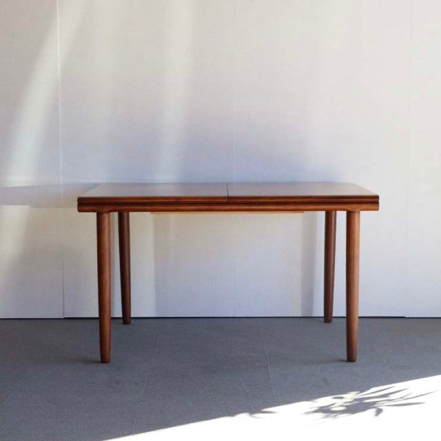 Vintage teak dining table by White AND Newton with rectangular top and tapered mid-century British legs, exhibiting rich.