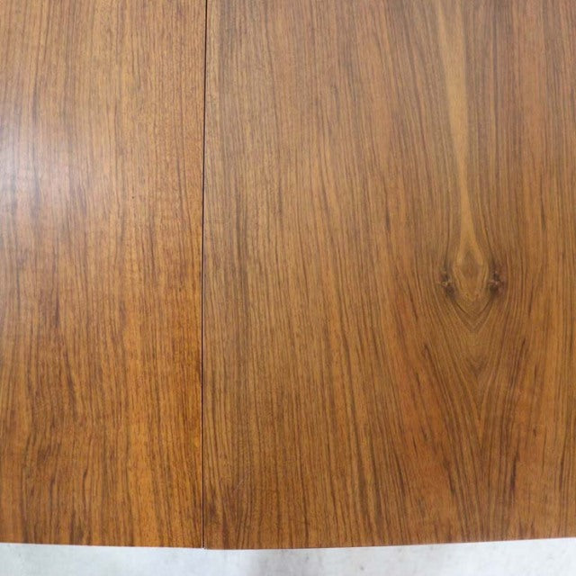 Vintage mid-century British dining table crafted from rich teak, showcasing natural wood grain and smooth finish.