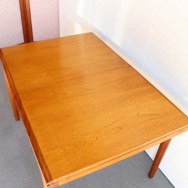 Vintage British mid-century teak dining table by WhiteANDnewton with rectangular top and tapered legs.