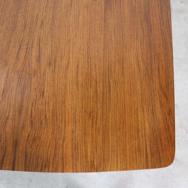 Vintage teak dining table top showing rich wood grain and smooth rounded edges in mid-century British-Danish design.