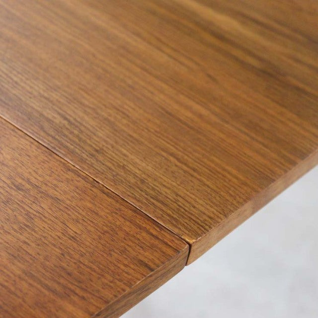 Vintage British mid-century teak dining table corner with rich wood grain and seamless rectangular edges.