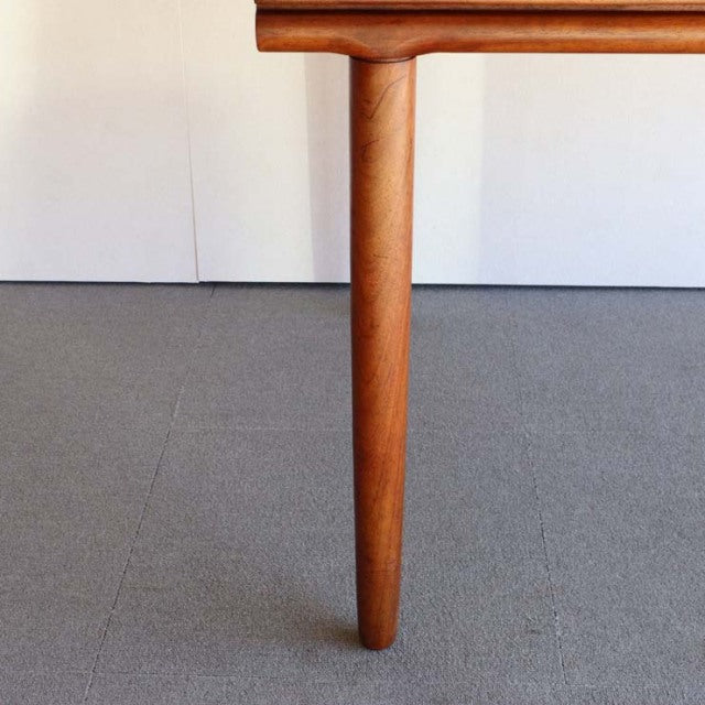 Mid-century British vintage dining table leg crafted from warm teak wood with smooth grain and rounded edge detail.