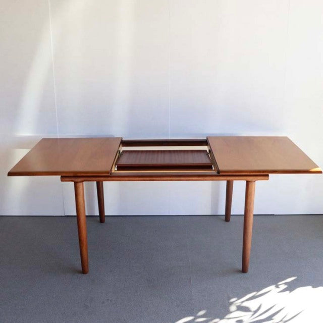 Mid-century British vintage teak dining table by WhiteANDnewton, rectangular top with extension, smooth wood grain, tapered.
