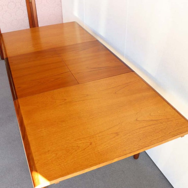 Mid-century British vintage teak dining table by WhiteANDnewton with rectangular top and smooth wood grain.