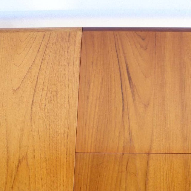 Vintage British mid-century teak dining table with rectangular top featuring rich wood grain and clean lines.