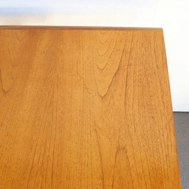 Vintage British mid-century teak dining table corner with smooth wood grain and clean rectangular edge.