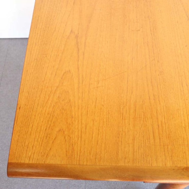 Vintage teak rectangular dining table with smooth wood grain, British mid-century design from White AND Newton.