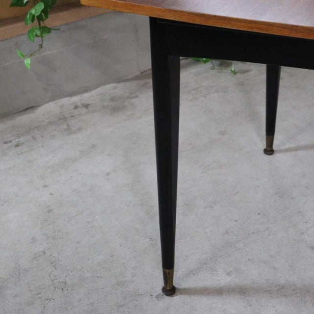 Mid-century British vintage teak dining table leg with black tapered wood and brass foot cap.