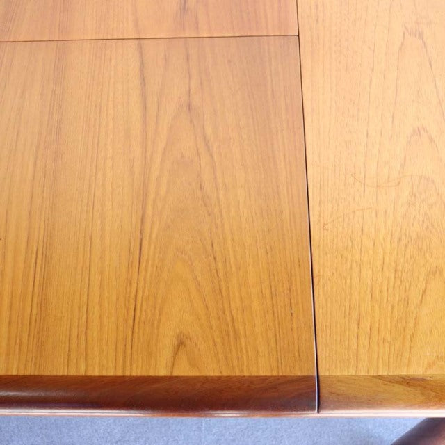 Vintage British mid-century teak dining table by WhiteANDnewton with smooth wood grain and sleek rectangular design.