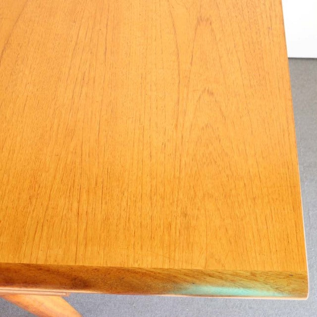 Vintage British mid-century teak dining table with rectangular top and smooth wood grain from WhiteANDnewton.