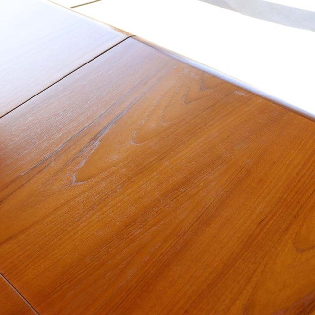 Vintage British mid-century teak dining table top with smooth wood grain and rich warm tones.