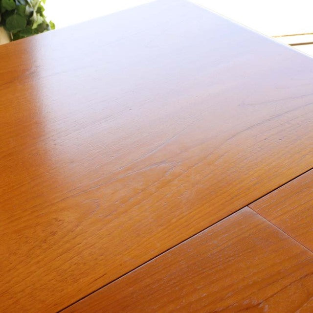 Vintage mid-century British teak dining table by WhiteANDnewton with smooth wood grain and rectangular top.