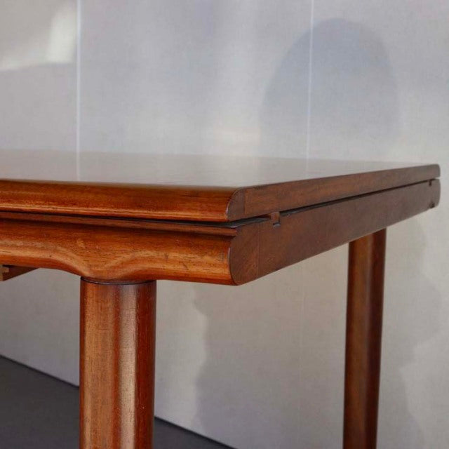 Vintage British mid-century teak dining table with rectangular top, smooth wood grain, and tapered legs, by WhiteANDnewton.