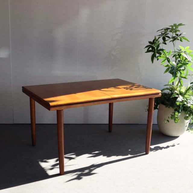Mid-century British vintage teak dining table by WhiteANDnewton with rectangular top and tapered legs.