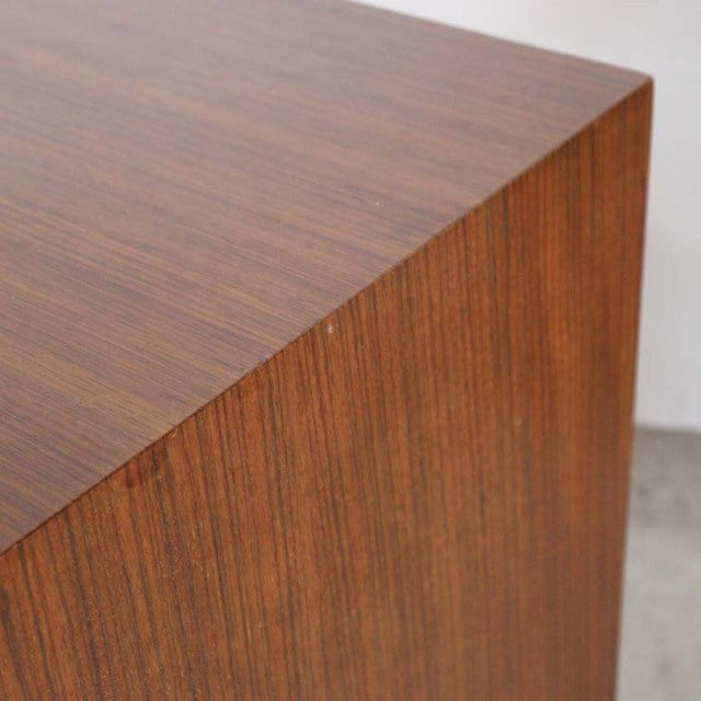 Vintage Meredew British teak chest corner showing rich wood grain and smooth mid-century finish.