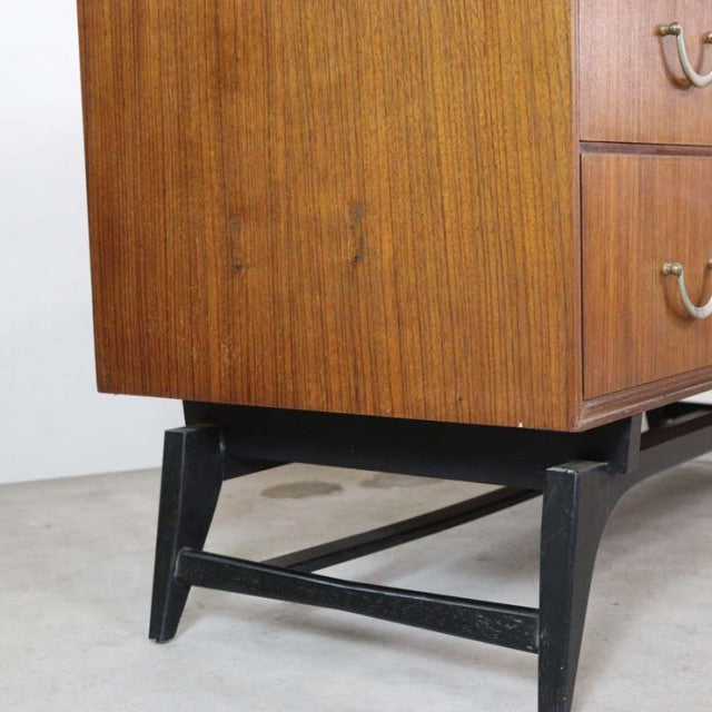 Vintage teak mid-century chest with rich wood grain, British-made by Meredew, black tapered legs with stretcher supports.
