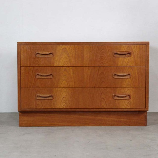 Vintage mid-century British G-Plan Fresco teak chest of drawers with three drawers and sculpted handles.