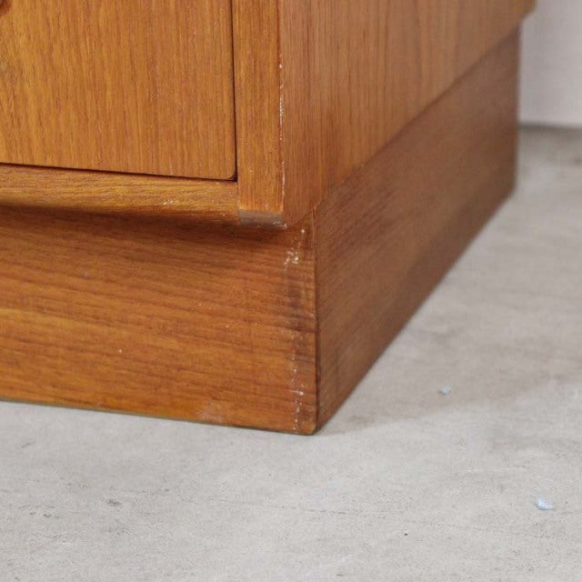 Vintage teak G-Plan mid-century chest corner showing rich wood grain and sturdy base from Denmark.