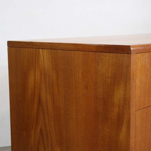 Vintage British G-Plan mid-century teak chest with clean lines and visible wood grain paneling.