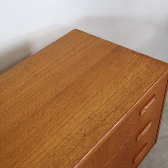 Vintage mid-century G-Plan teak three-drawer chest with smooth wood grain and rounded recessed handles, British design.