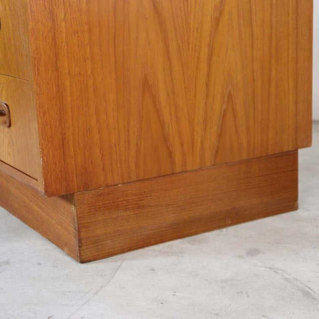 Close-up of vintage teak wood grain on British mid-century G-Plan Fresco 3-drawer chest base and side panel, showcasing warm .