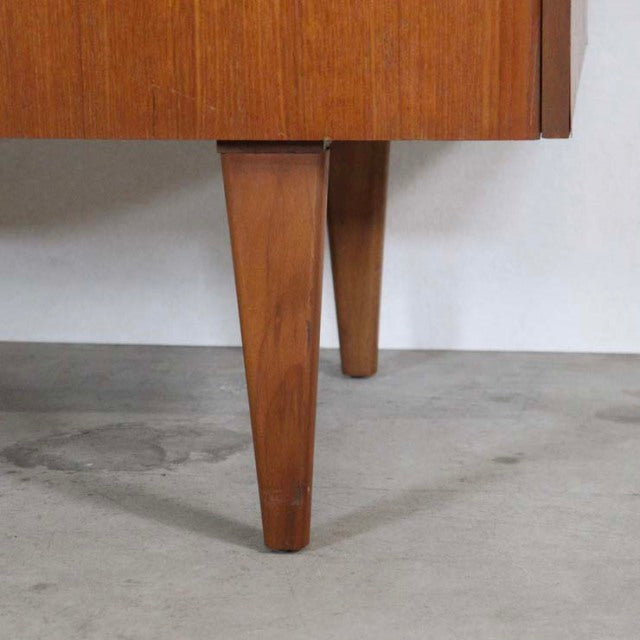 Mid-century British vintage teak sideboard legs with tapered, angled design and warm wood grain finish.