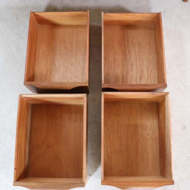 Four vintage teak drawers with visible wood grain and clean mid-century British design edges, likely from a.