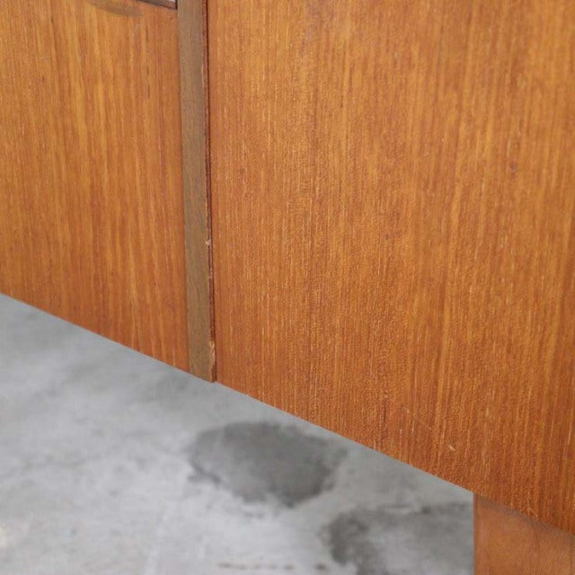 Close-up of mid-century British vintage teak sideboard showing wood grain and clean lines.