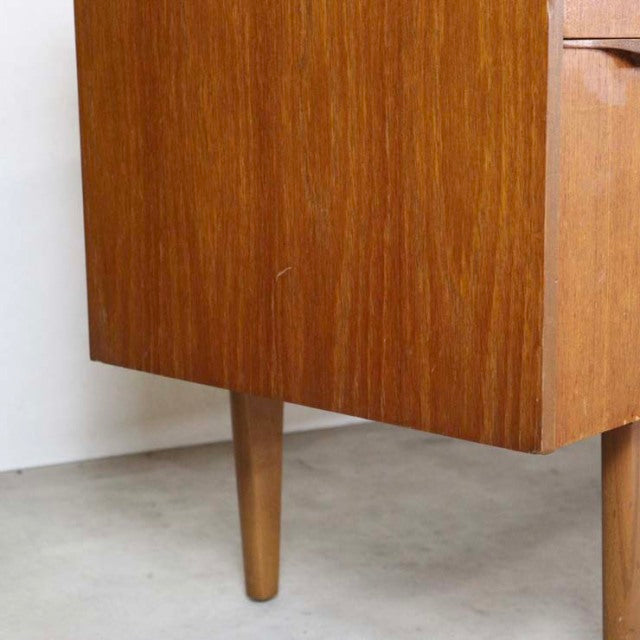 Vintage teak British mid-century sideboard leg detail with smooth wood grain and tapered leg.