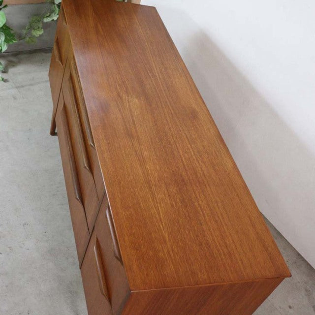Mid-century British vintage teak sideboard from Denmark with rich wood grain and tapered legs.