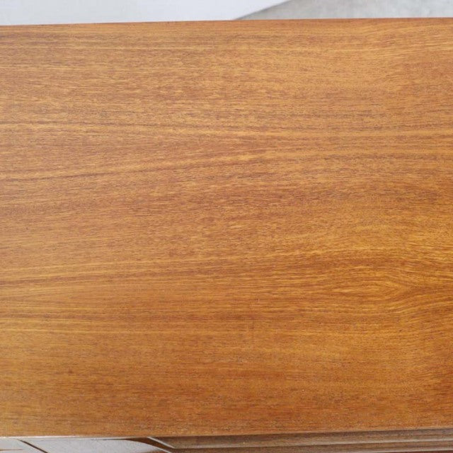 Vintage teak British mid-century sideboard top with smooth wood grain and warm honey tones.