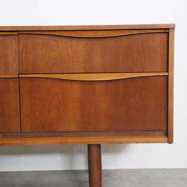 Mid-century British vintage teak sideboard by Austinsuite with rich wood grain and tapered legs, Denmark style influences.