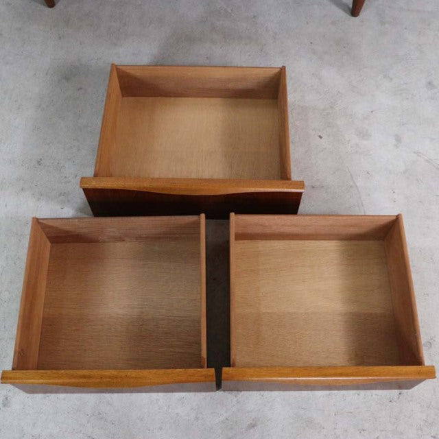 Three open teak drawers with visible wood grain, vintage British mid-century design by Austinsuite, sturdy rectangular form, .