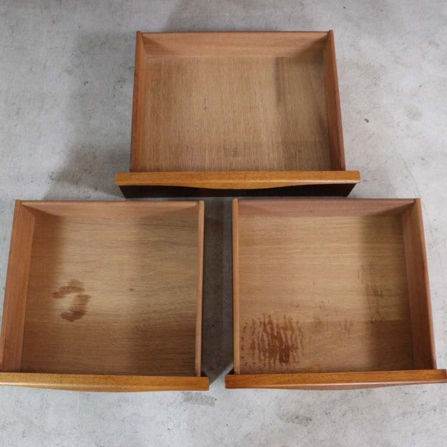Set of three vintage teak drawers with visible wood grain and mid-century Danish design, smooth edges and clean lines.