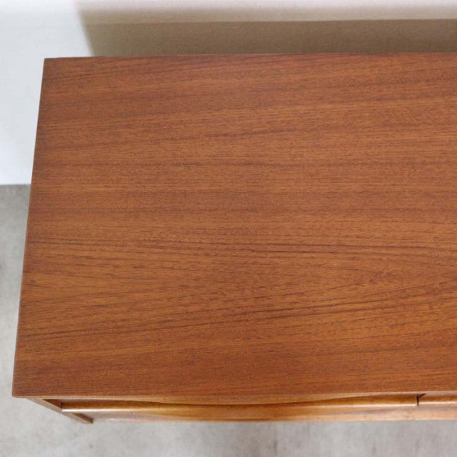 Vintage mid-century British teak sideboard top with smooth wood grain and warm tones from Austinsuite.