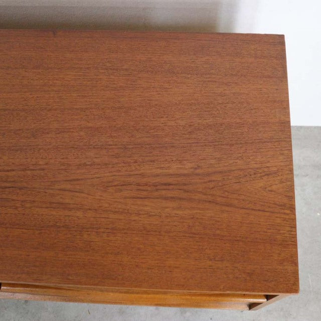 Vintage British mid-century teak sideboard top surface with rich wood grain and warm tones.