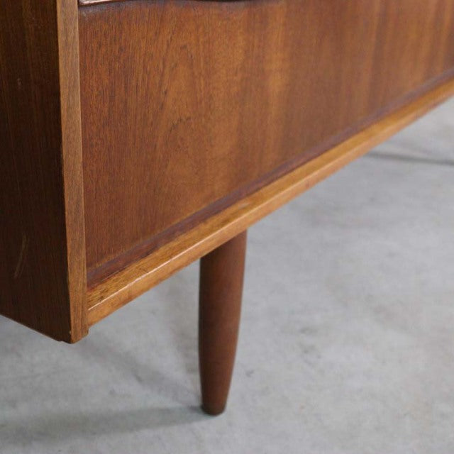 Mid-century British vintage teak sideboard leg with smooth wood grain and tapered cylindrical design from Austinsuite.