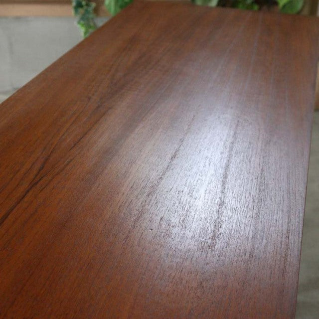 Vintage teak sideboard top with rich wood grain and smooth mid-century British finish.