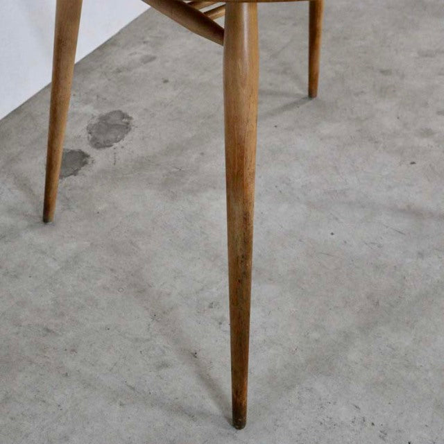 Mid-century British vintage teak dining table leg with tapered design and visible wood grain from ERCOL.