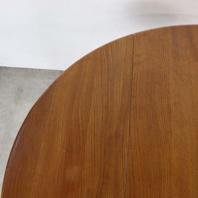 Vintage British mid-century teak dining table with smooth wood grain and rounded edge drop-leaf design.