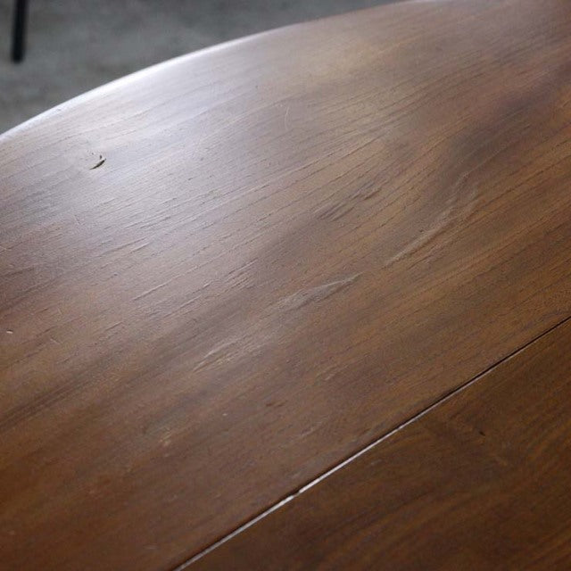 Mid-century British vintage Ercol dining table drop-leaf in teak with smooth grain and rounded edges.