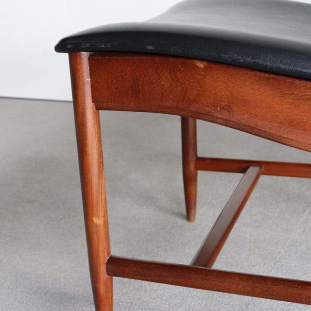 Mid-century British vintage teak dining chair with black leather seat and angled legs, showcasing rich wood grain and sturdy .