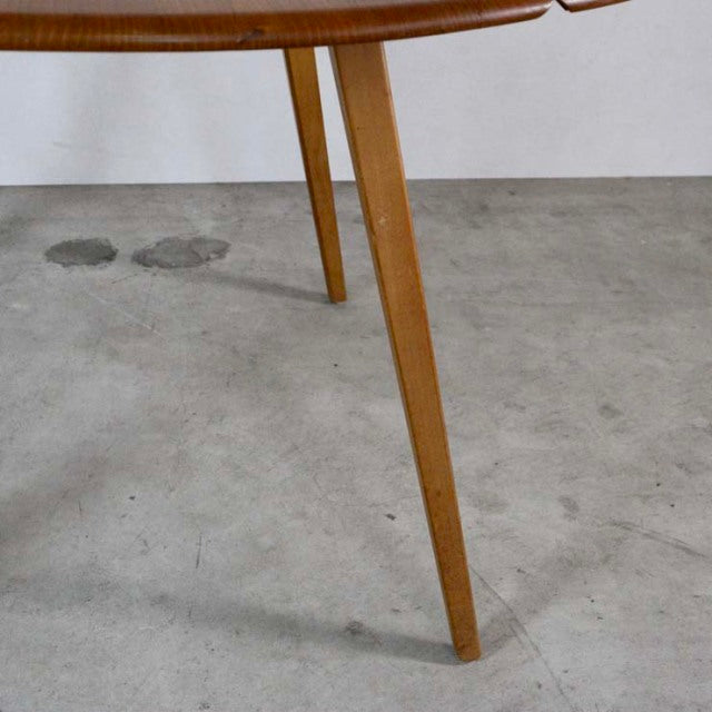 Mid-century British vintage Ercol teak dining table leg with visible wood grain and smooth rounded edges.