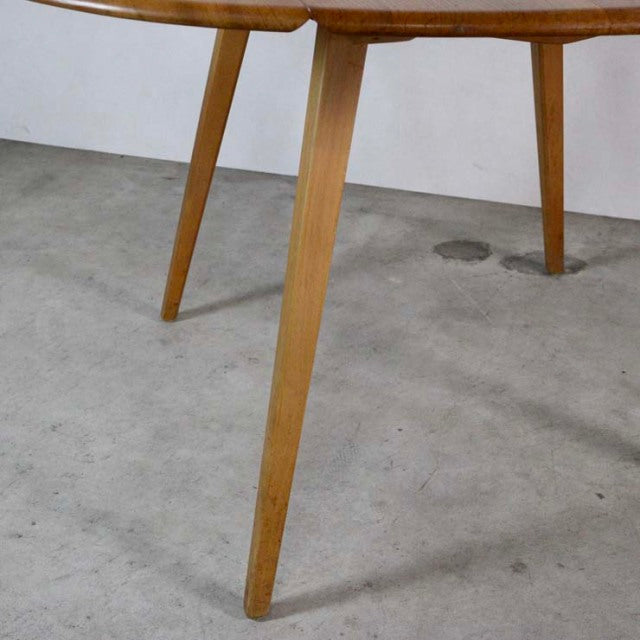 Mid-century British vintage Ercol dining table leg in warm teak with distinctive tapered design and natural wood grain.