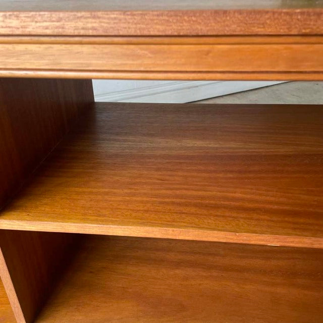 Vintage teak mid-century British TV board with smooth wood grain and minimalist iron legs.