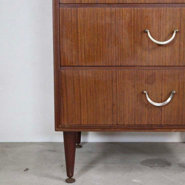 Mid-century British vintage teak six-drawer chest with rich wood grain and tapered legs by MEREDEW.